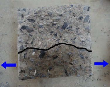 Obr. 8 – Průsak tlakové vody [2] ve zkušebním tělese z betonu s krystalizační příměsí, bez ošetřování (únik vody přes stěny tělesa během zatěžování)