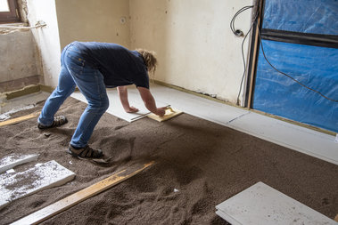 Podsyp z Liaporu připravujeme vždy v pruzích jen o cca 20 % širších než jsou podlahové desky a průběžně zaklápíme